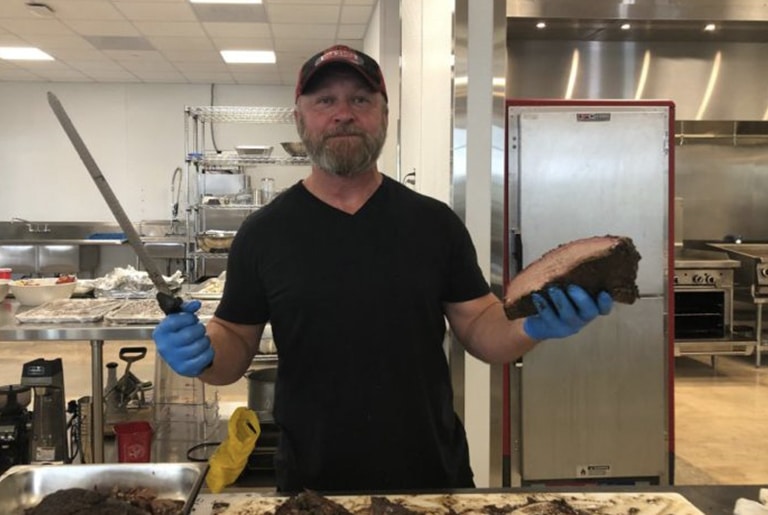 chef holding knife and roast