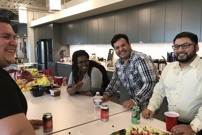 staff enjoying snacks in breakroom smiling