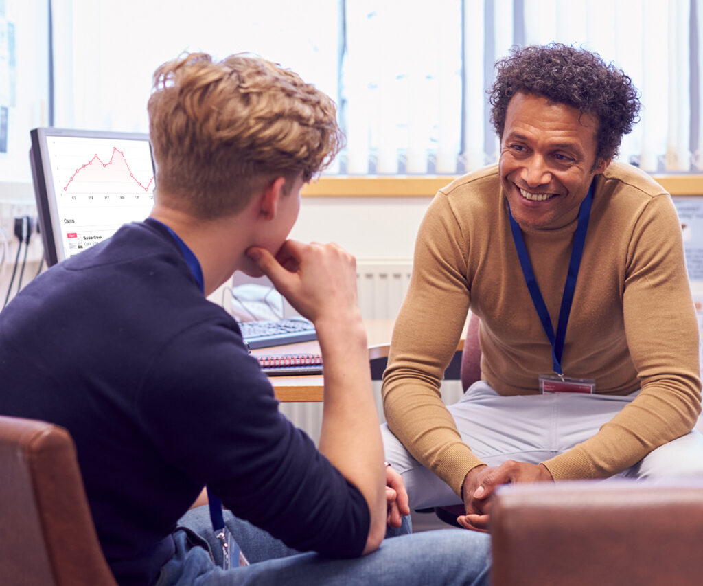 guidance counselor sitting and smiling with student