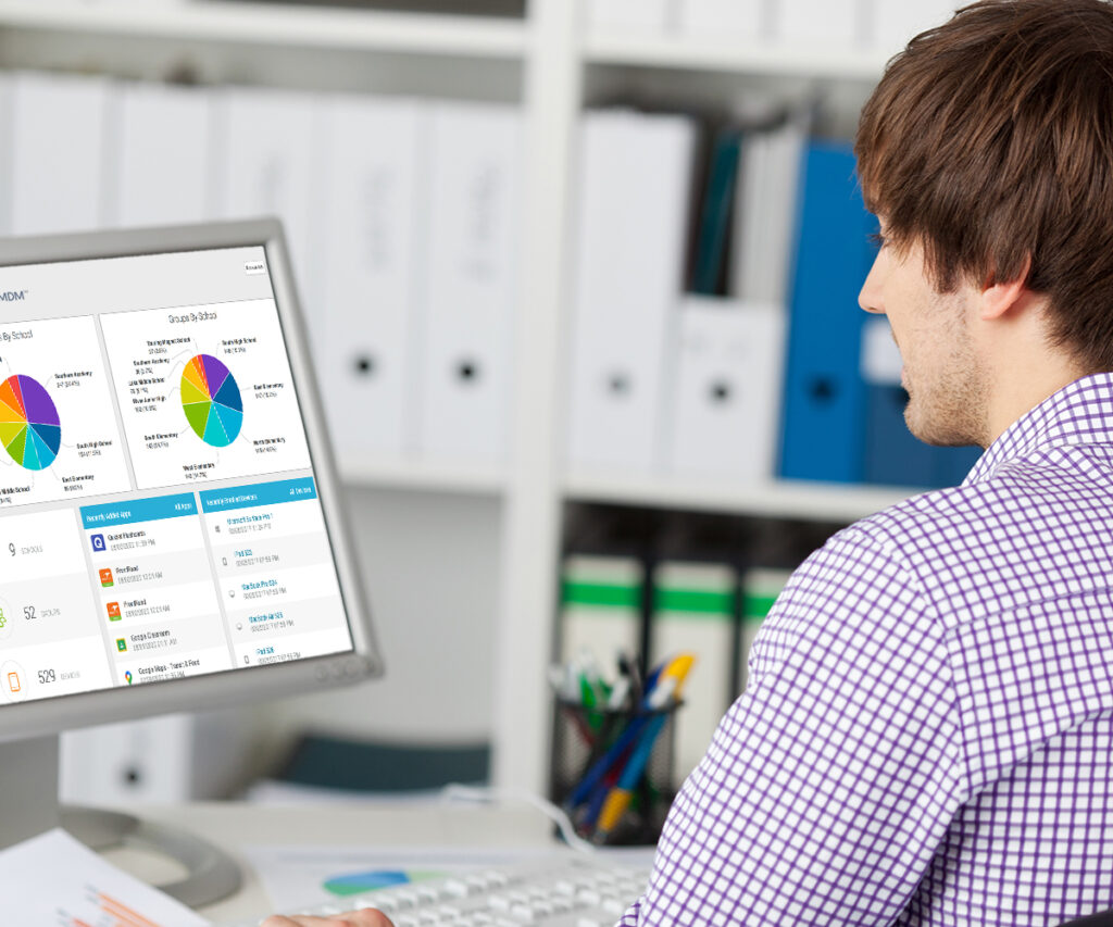 man typing on desktop computer with Ligthspeed MDM dashboard on screen